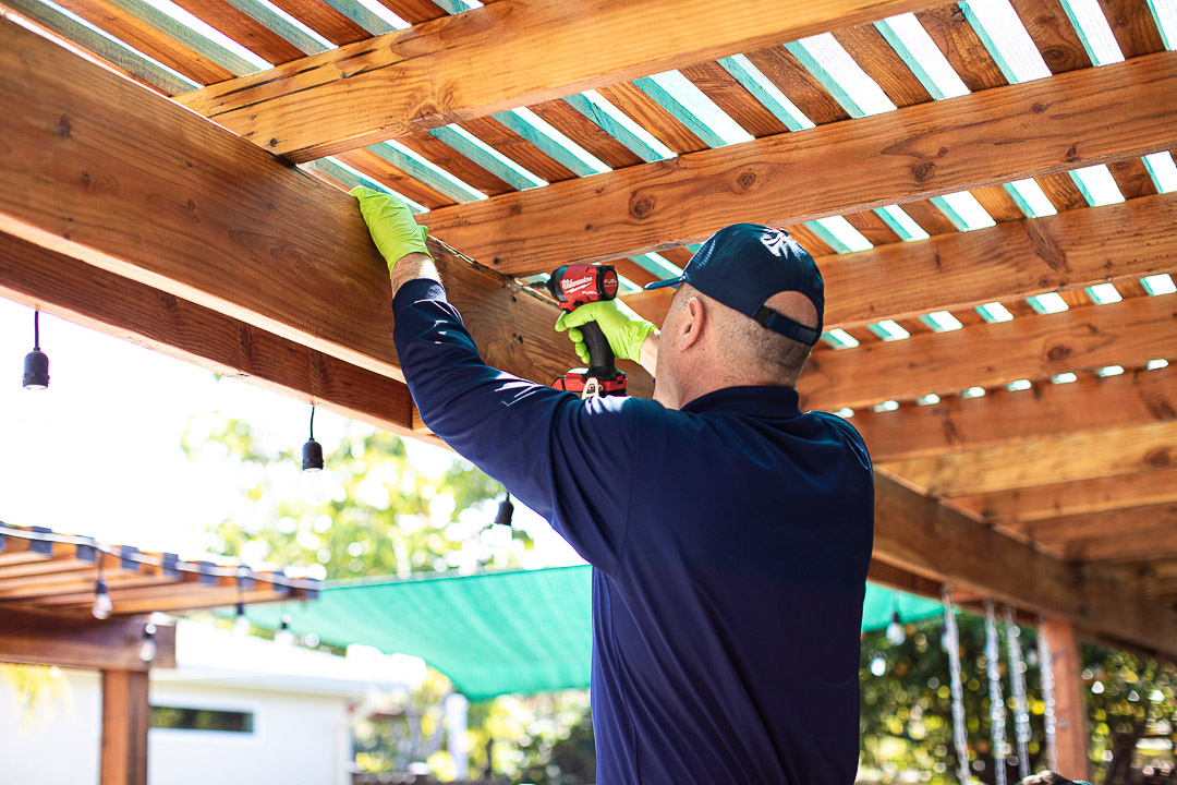 DePests technician performing professional wood repair on damaged structure